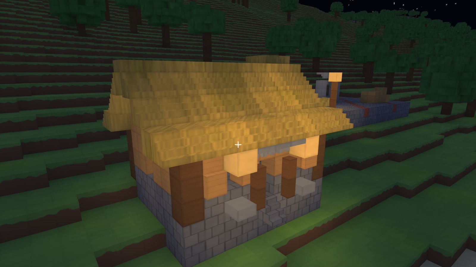 The same house at night lit by lanterns